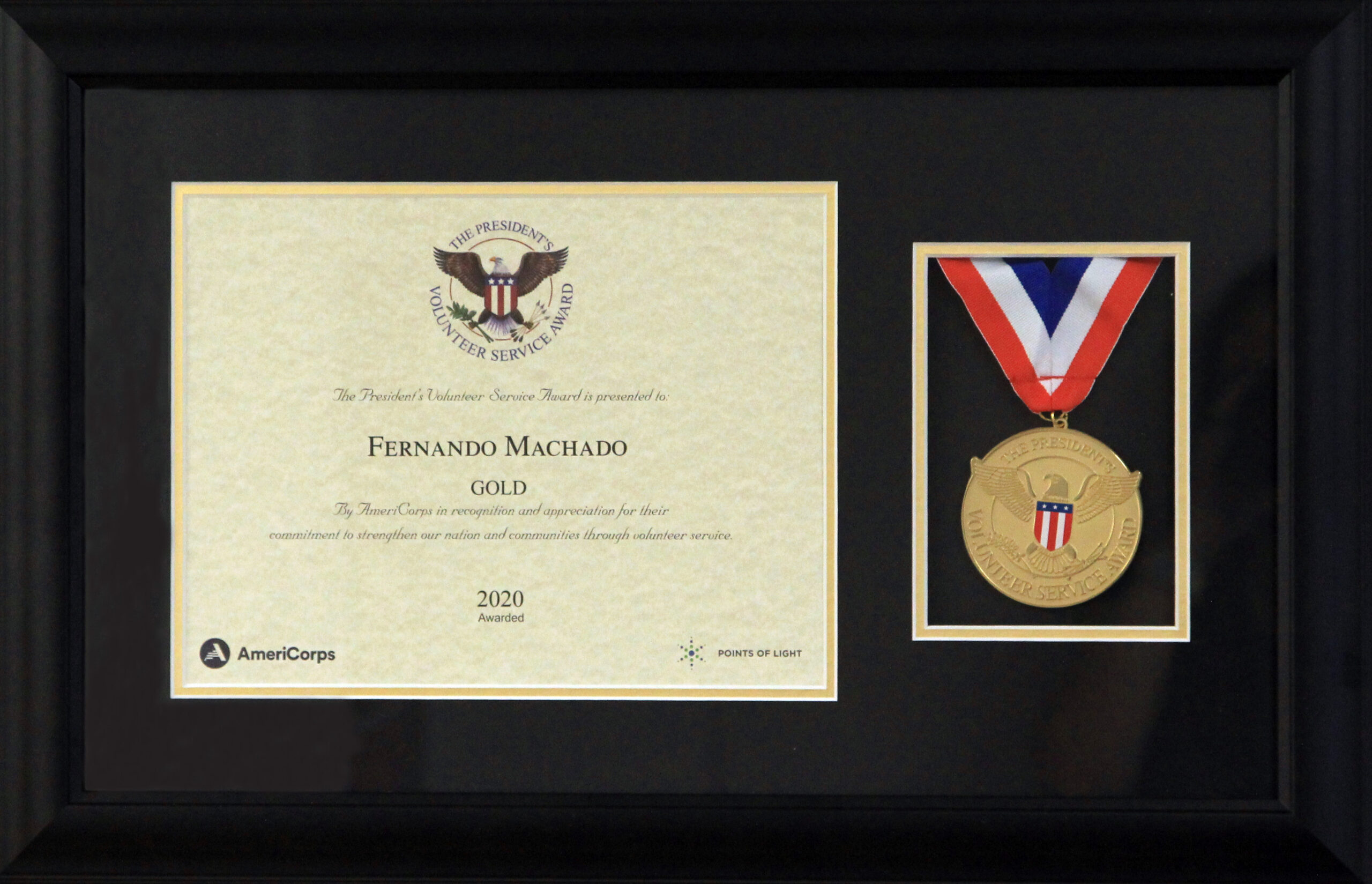 A framed medal and certificate of achievement