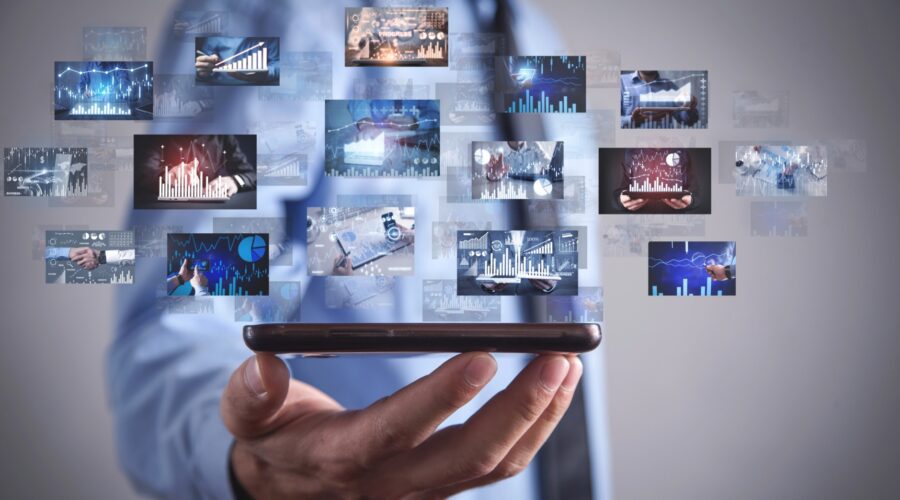 Businessman holding phone, financial data.