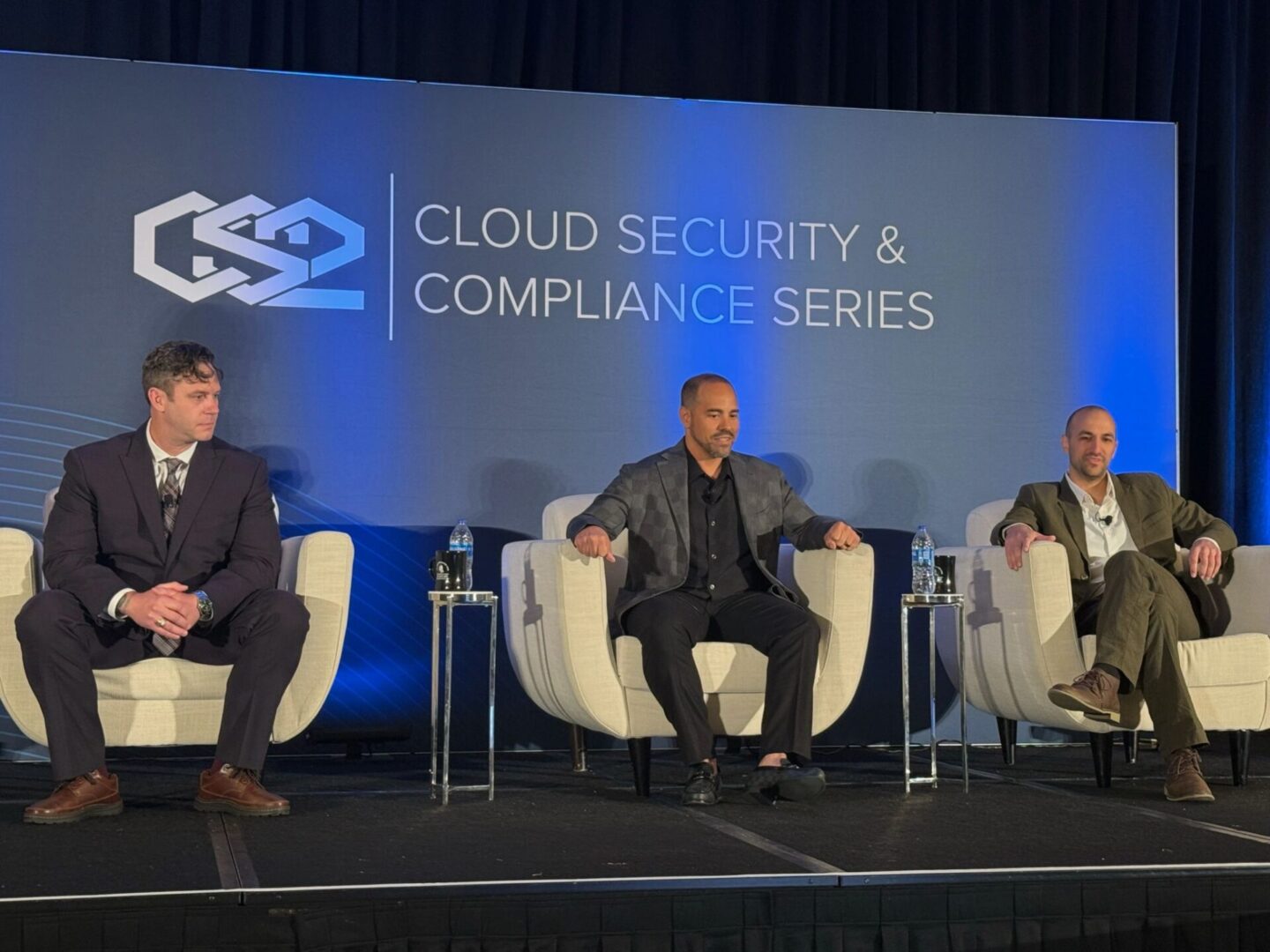 three men are sitting on the chairs for an event