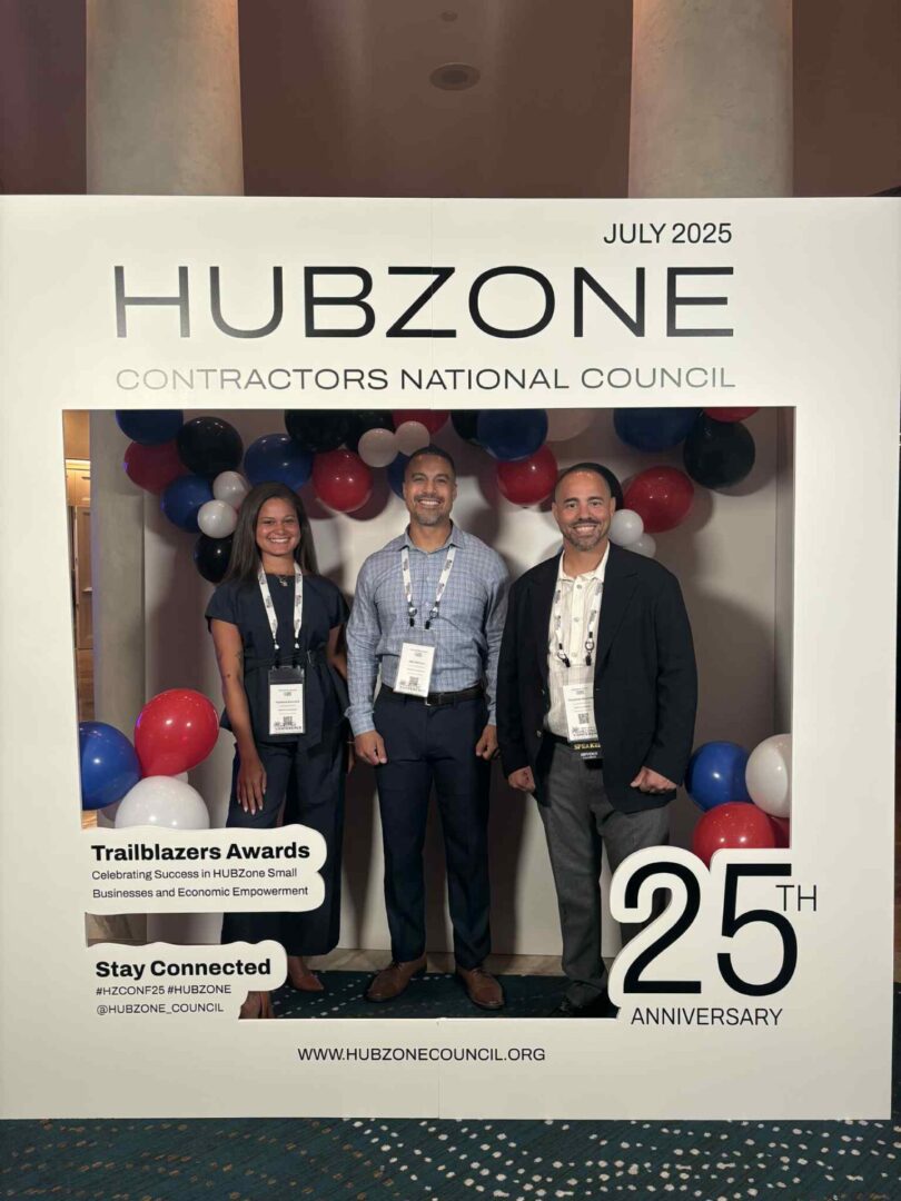 Three people at HUBZone event display.