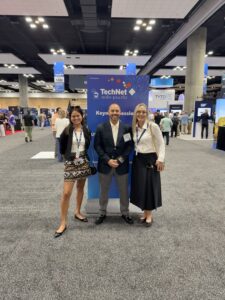 Three people posing at TechNet Indo-Pacific conference
