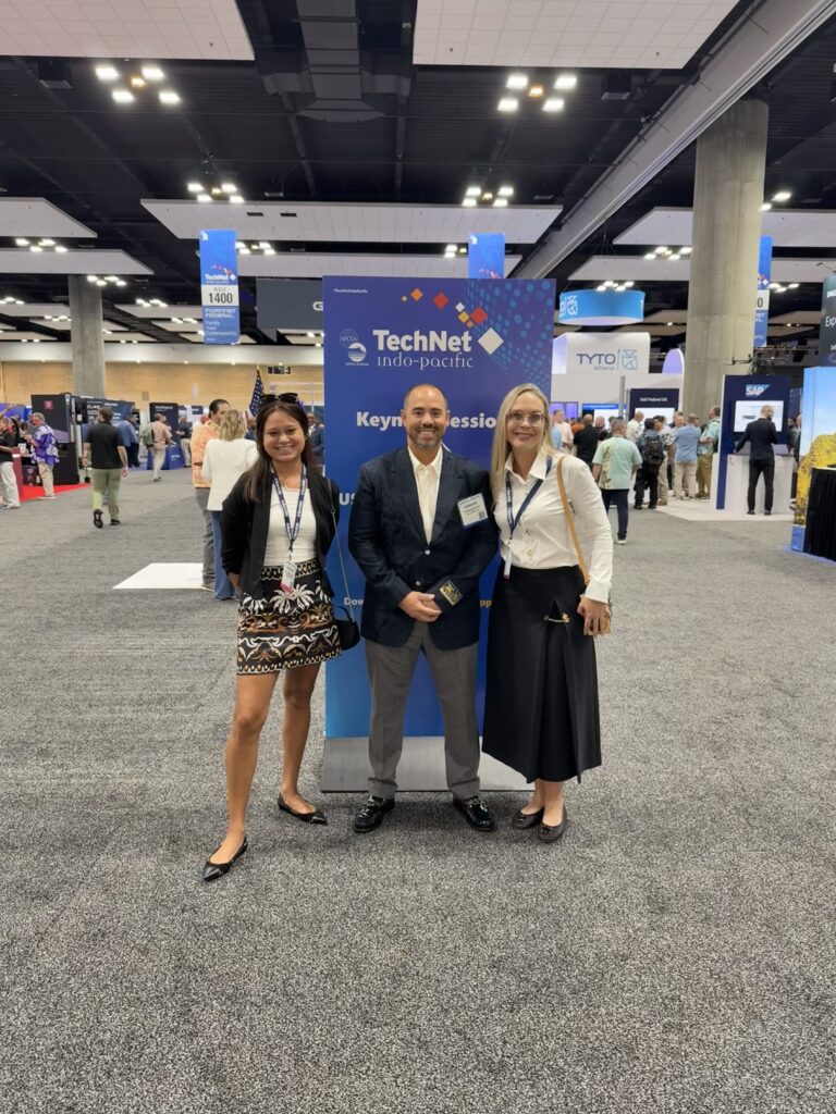 Three people posing at TechNet Indo-Pacific conference