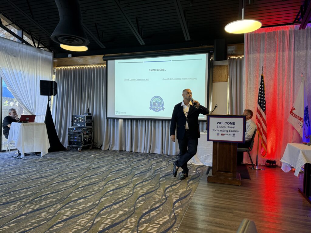 Speaker presenting at conference with projection screen